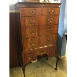 A walnut chest on stand with two short and three long drawers, below three short drawers