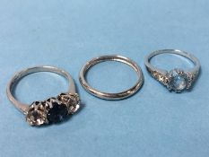 A 9ct white gold and diamond eternity ring and two dress rings