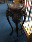 An Oriental carved pedestal, with inset marble top