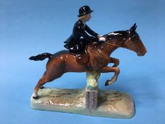 A Beswick figure 'Huntswoman' jumping over a fence, number 892