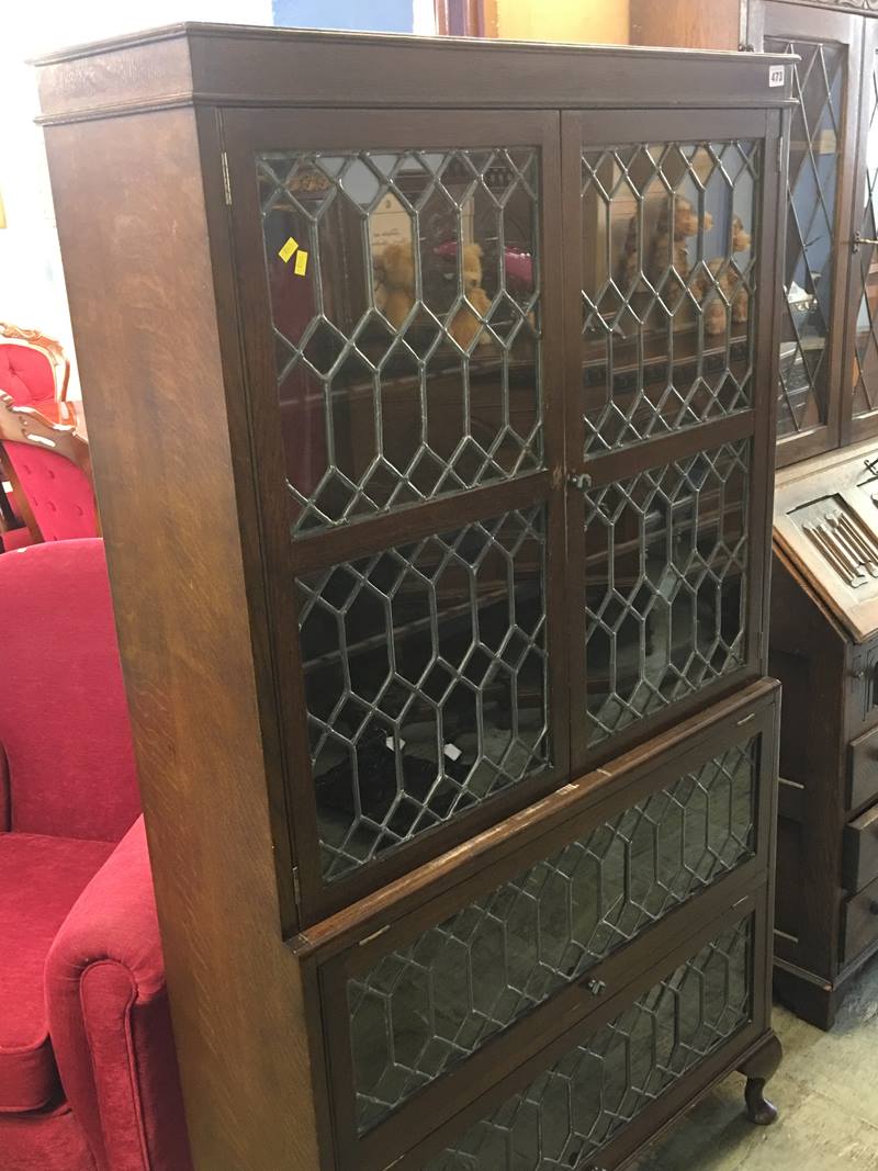 An oak leaded glass bookcase