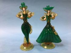 A pair of Murano figures of two ladies wearing hats, in green, white and amber, 40cm height