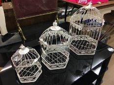 Three graduating bird cages