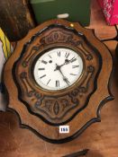 An oak cased wall clock