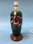 A Moorcroft table lamp on a mottled green ground, decorated with Iris's, 36cm height