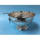A large silver plated punch bowl and a serving ladle