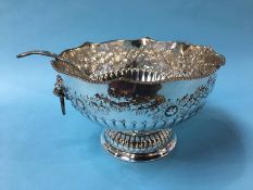 A large silver plated punch bowl and a serving ladle