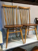 A pair of Ercol stick back chairs