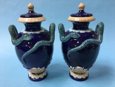 A pair of late 19th century Wilhelm Schiller and Sons, Continental majolica vase on a cobalt blue