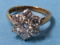 An 18ct gold diamond seven stone cluster ring, stamped 750, ring size K/L