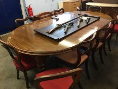 A Victorian mahogany dining table, with three leaves and a harlequin set of ten chairs