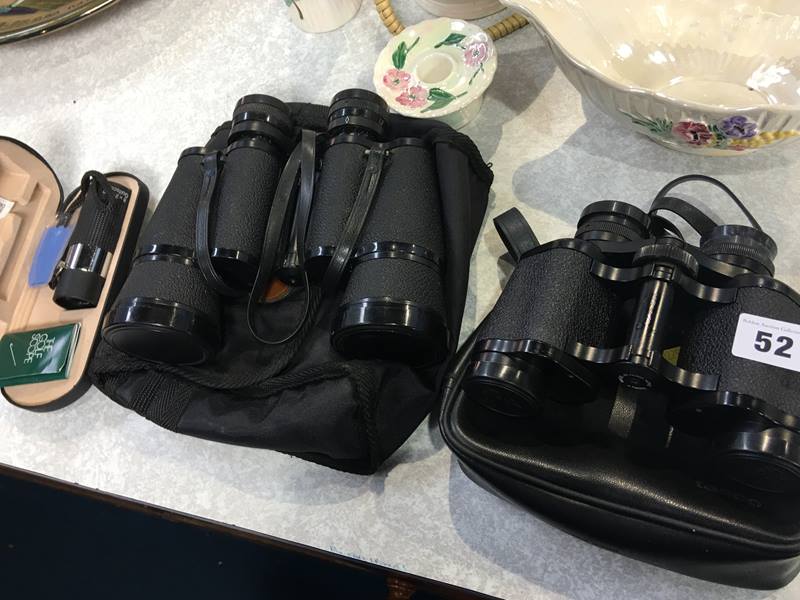 Two pairs of binoculars and a monocular