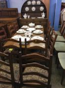 An oak dining room suite, with ten chairs