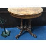A Victorian walnut demi lune fold over card table with marquetry inlay