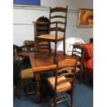 An oak drawer leaf table and five chairs