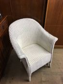 A white Lloyd Loom chair