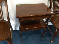 An Edwardian mahogany fold over two tier card table