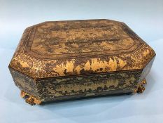 An early 20th century lacquered games casket opening to reveal; five lidded boxes and various trays,