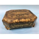 An early 20th century lacquered games casket opening to reveal; five lidded boxes and various trays,