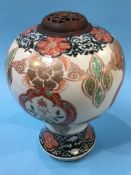 A Japanese Satsuma ware vase of onion shape, decorated with stylised panels and exotic birds, signed