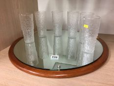 Eleven Taza glasses and a mirror