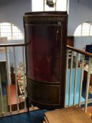 A Louis XV style standing corner cabinet with bow front and glazed doors