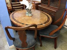 A Victorian walnut oval table with quarter top, parquetry inlaid, with a set of four chairs