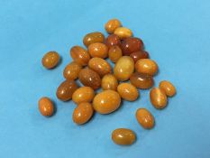 A quantity of amber coloured beads, approx. 50g