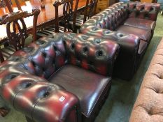 A Chesterfield Oxblood three seater settee and a club chair