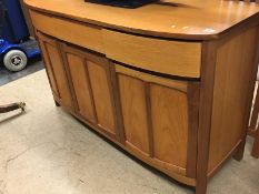 A teak bow front sideboard, teak drop leaf table and two chairs