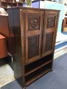 A carved oak two door cabinet