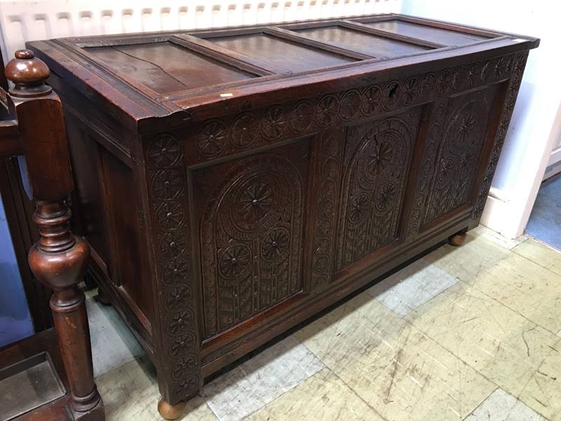 A carved oak coffer