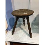 A carved oak circular stool