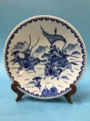 A Chinese blue and white charger decorated with Warriors, marks in underglaze blue, 34cm diameter