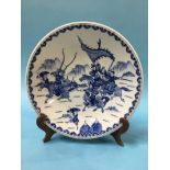 A Chinese blue and white charger decorated with Warriors, marks in underglaze blue, 34cm diameter