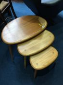 A nest of three Ercol Golden Dawn 'Pebble' tables