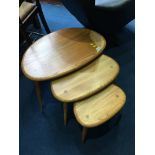 A nest of three Ercol Golden Dawn 'Pebble' tables