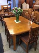 An oak dining table and a set of six barley twist chairs