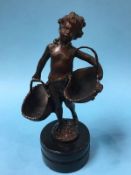 A small bronze of a boy holding two baskets, 29cm height
