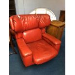 A large red leather swivel armchair with matching footstool