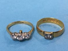 A 22ct diamond ring (4g) and an 18ct three stone diamond ring (2.8g)