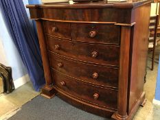 A Victorian mahogany bow fronted chest of drawers, with cushion drawer below two short and three