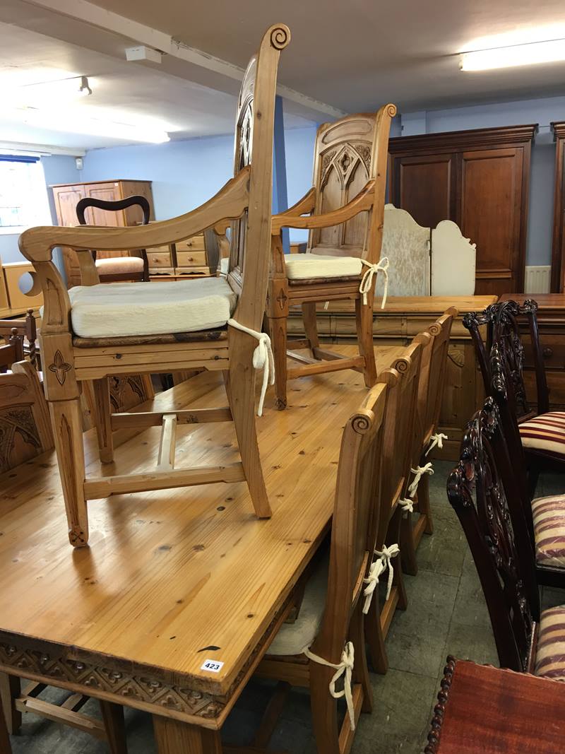 A pine Gothic style Farmhouse dining table, sideboard and eight chairs, comprising six single and