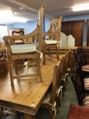 A pine Gothic style Farmhouse dining table, sideboard and eight chairs, comprising six single and