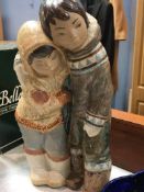 Lladro figure group of two Eskimos with arms around each other. Height 33 cm