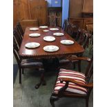 A reproduction mahogany dining table and eight chairs
