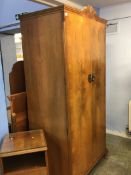 A walnut wardrobe, bedside cabinet, dressing table and headboard