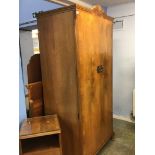 A walnut wardrobe, bedside cabinet, dressing table and headboard