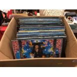 A box of heavy metal vinyl records, including a signed 'Steve Vai' album
