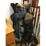 Four sets of golf clubs and a trolley